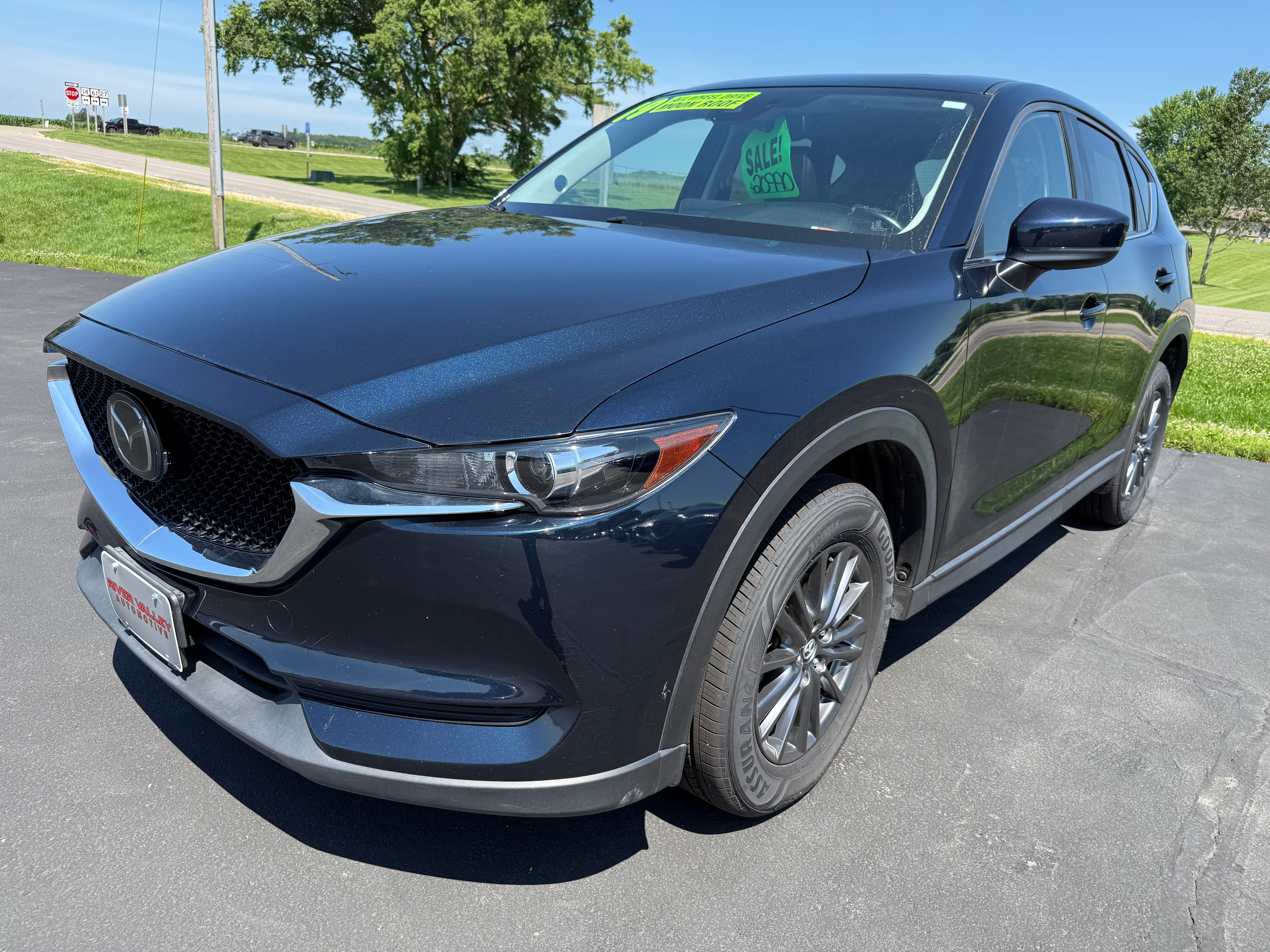 2019 Mazda Mazda CX-5 Touring in Deep Crystal Blue Mica — front three-quarter view